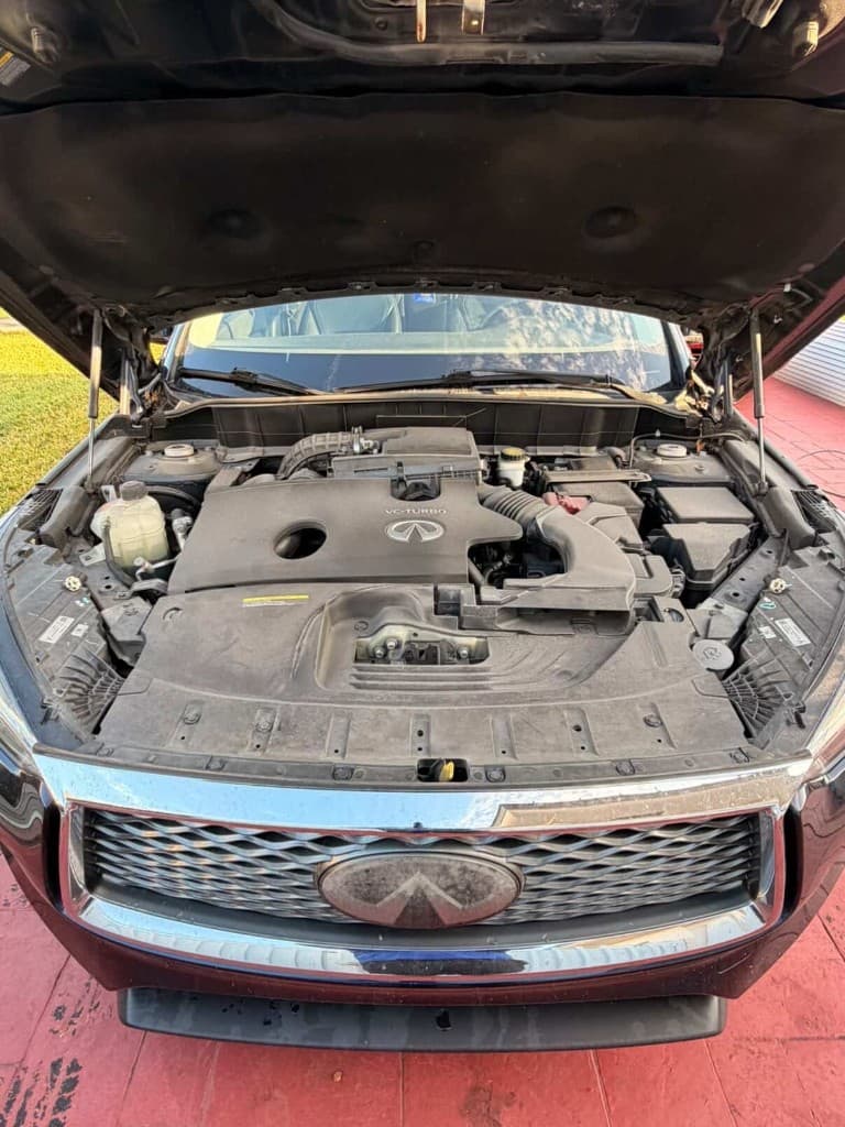 Infiniti VC-Turbo engine bay with hood open before detailing